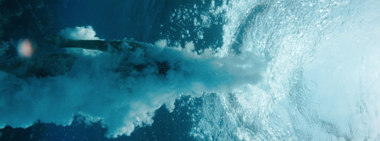 a large body of water with a wave coming out of it