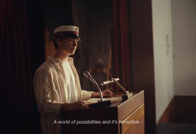 a man standing at a podium in front of a microphone