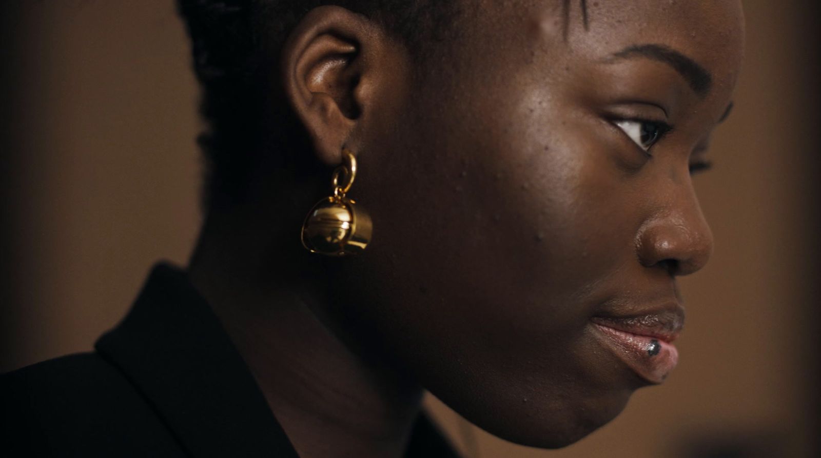 a close up of a person wearing a pair of earrings