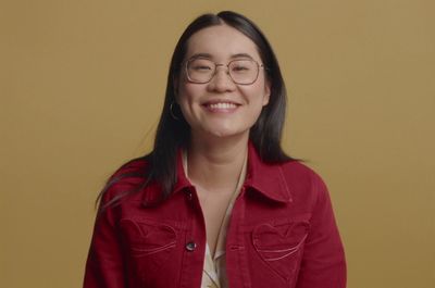 a woman wearing glasses and a red jacket