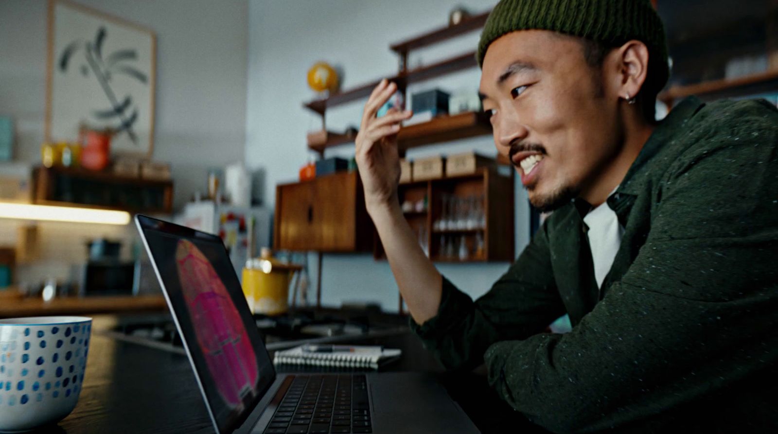 a man sitting in front of a laptop computer