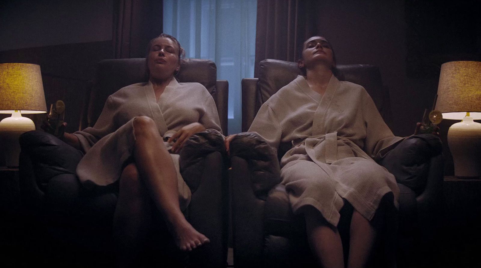 a couple of people sitting on top of a couch