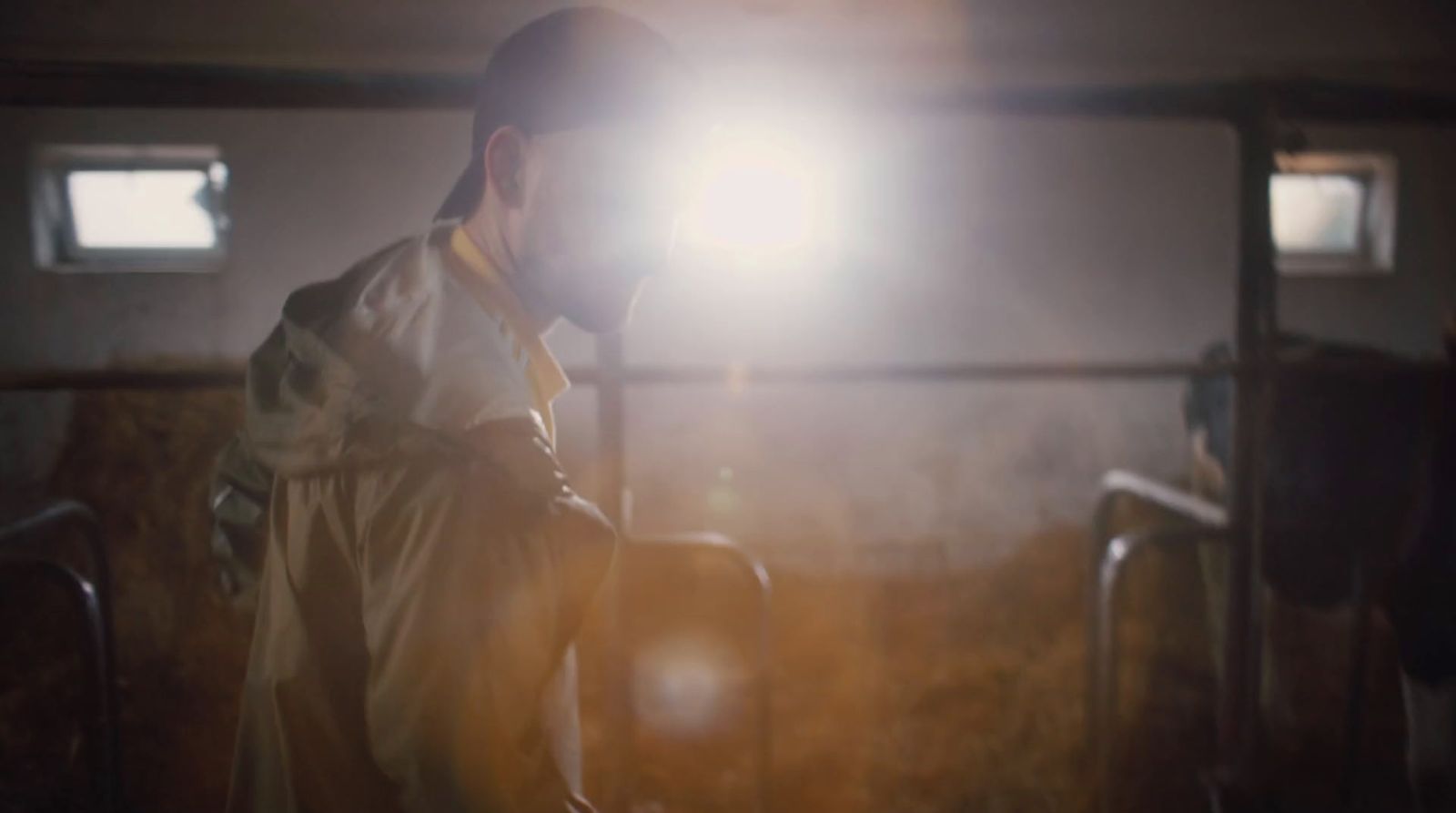 a man standing in a room with a light on