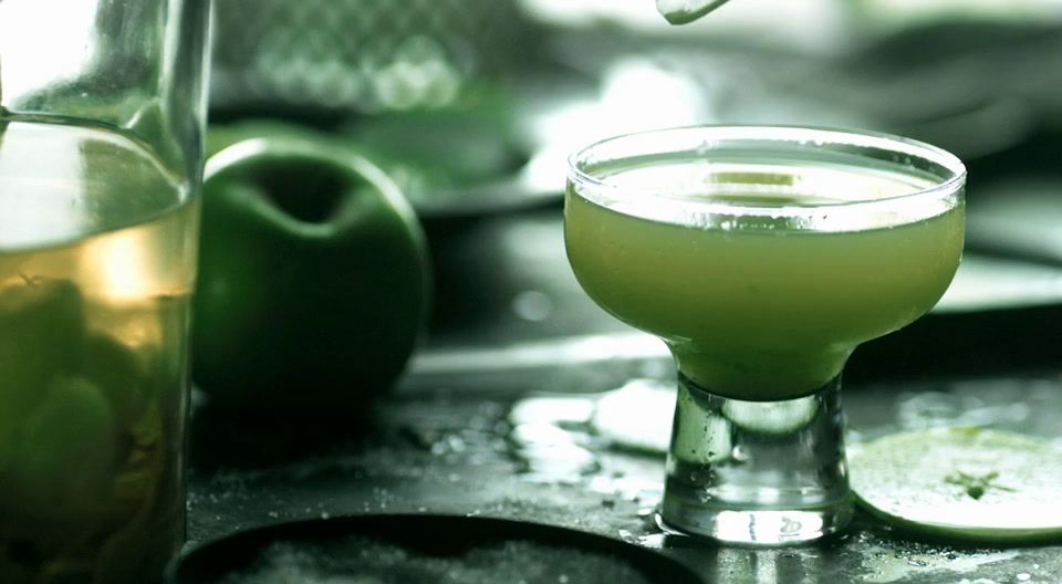 a close up of a drink in a glass on a table