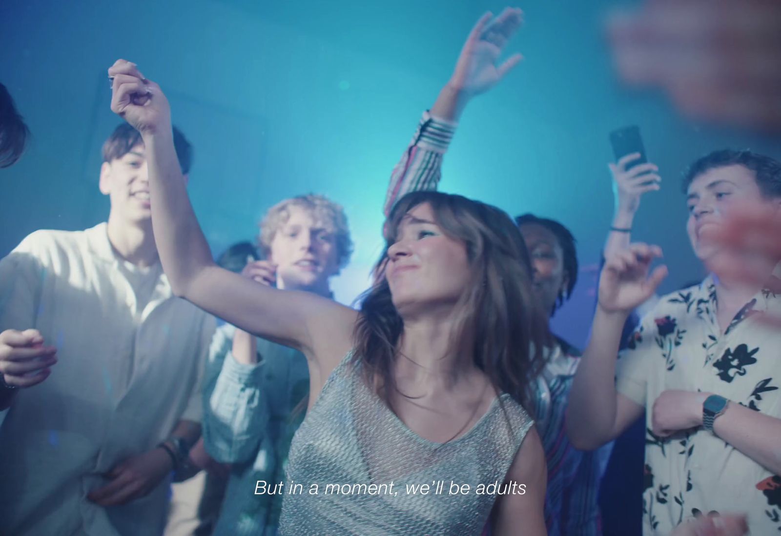 a woman standing in front of a crowd of people