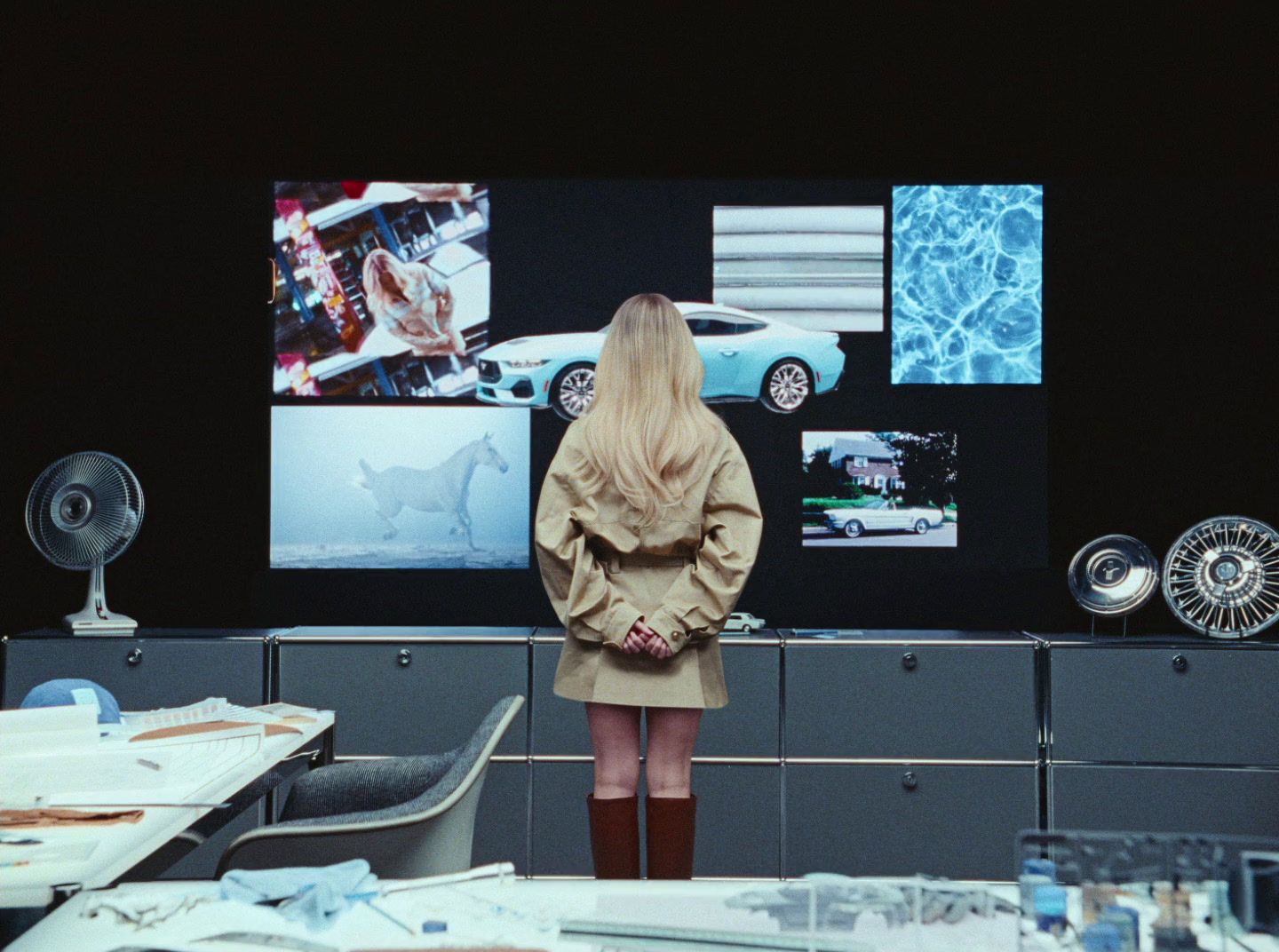 a woman standing in front of a computer screen