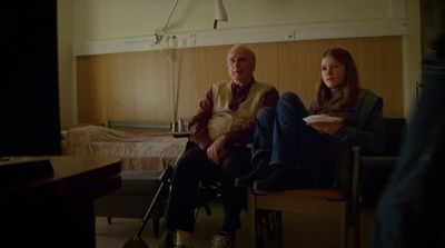 a man and a woman sitting in a room
