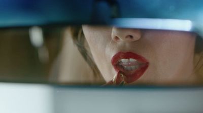 a woman sticking her tongue out in front of a mirror