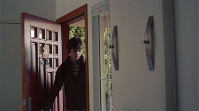 a man standing in front of a red door
