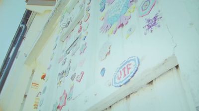 a close up of a wall with a lot of stickers on it