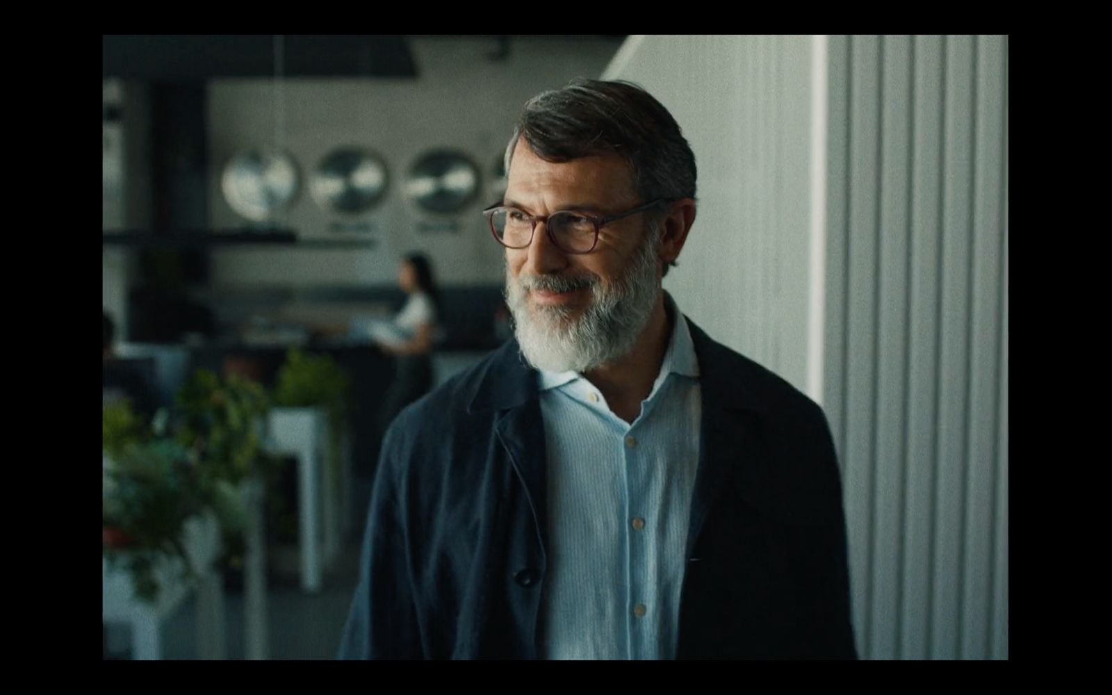 a man with a white beard wearing glasses