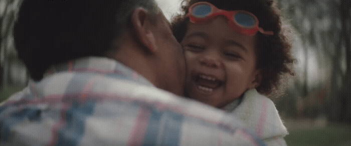 a man holding a little girl in his arms
