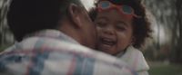 a man holding a little girl in his arms