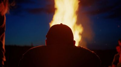 a person standing in front of a fire