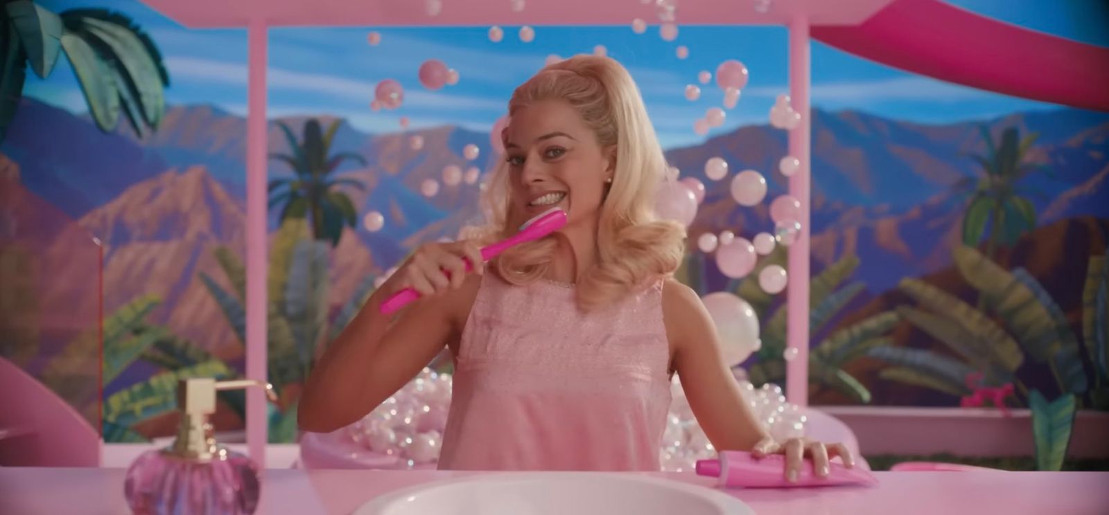 a woman brushing her teeth in front of a mirror