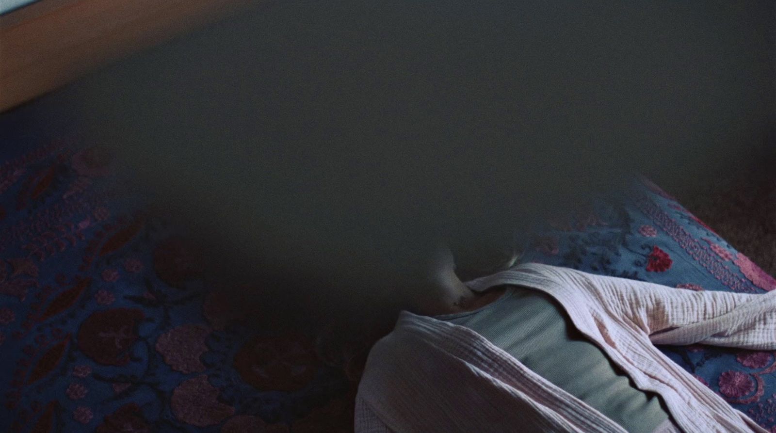 a person laying on a bed in a room