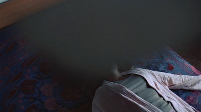 a person laying on a bed in a room