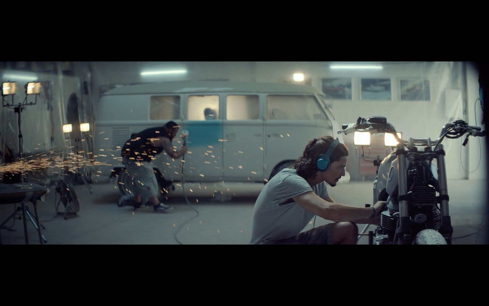 a woman is working on a motorcycle in a garage