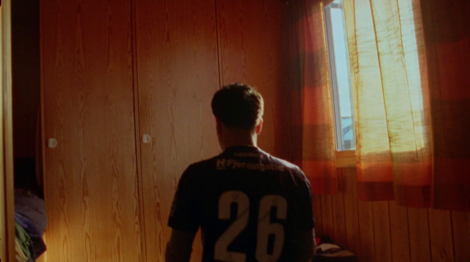 a man standing in front of a window in a room