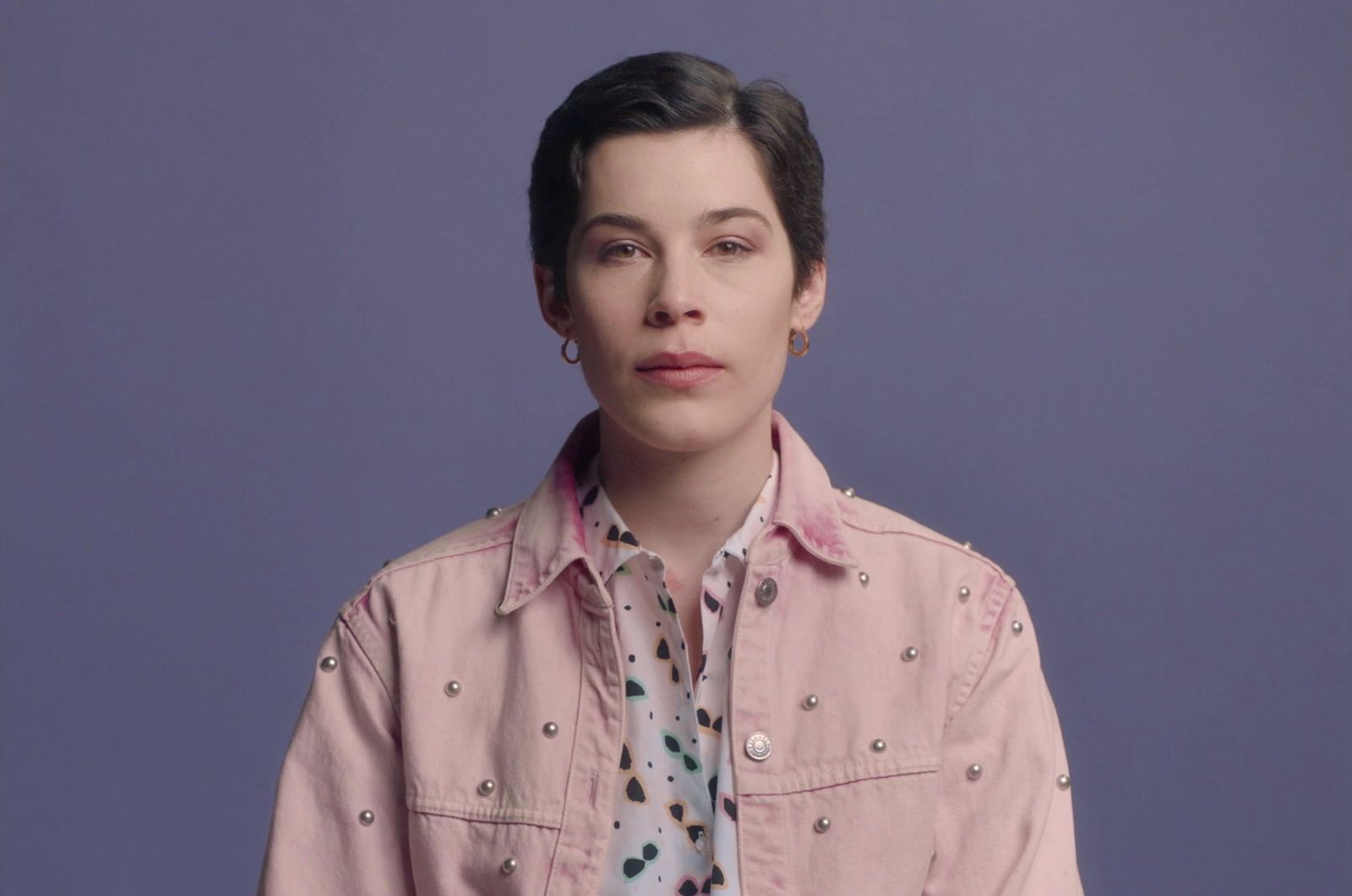 a woman in a pink shirt is posing for a picture