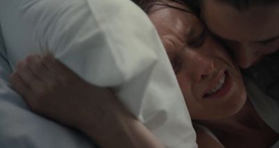 a man and a woman cuddling under a blanket