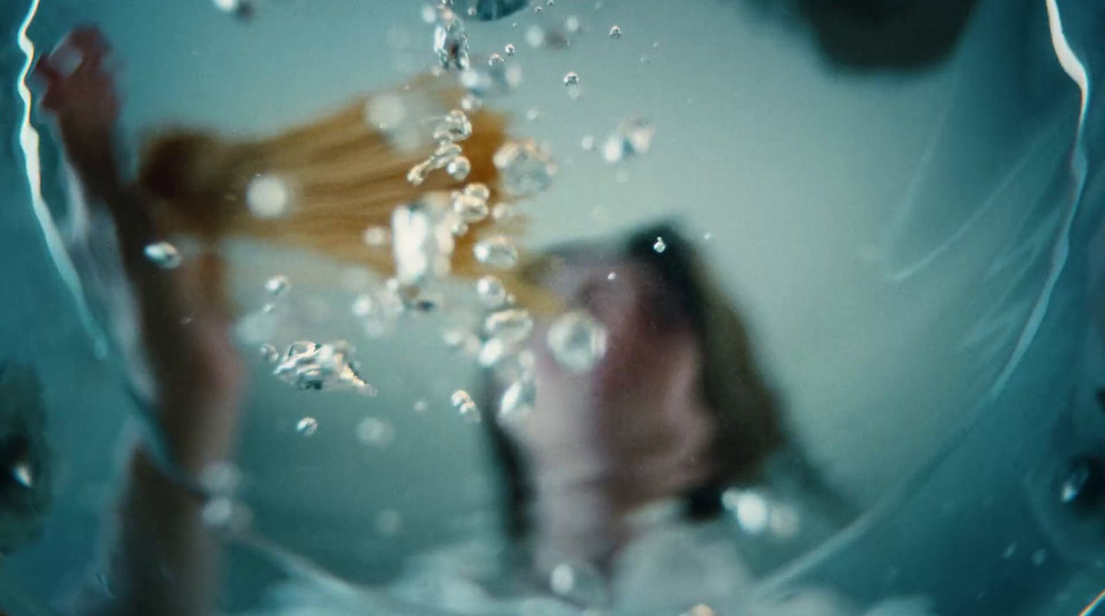 a close up of a person holding a hair dryer