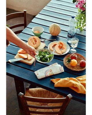 a person is cutting a sandwich on a table