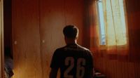 a man standing in front of a window in a room