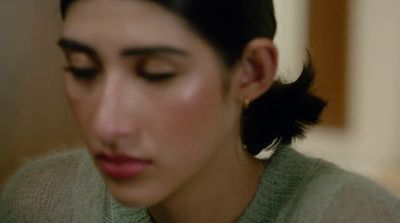 a close up of a person wearing a sweater