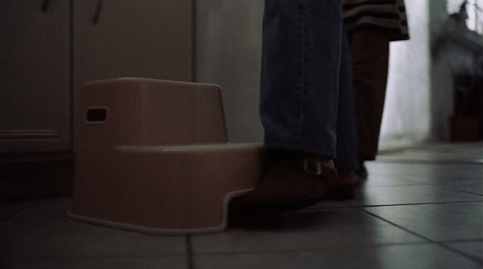 a person standing next to a step stool