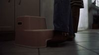 a person standing next to a step stool