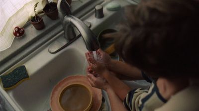 a person washing their hands in a sink