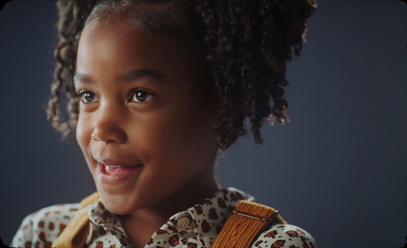 a close up of a child with curly hair