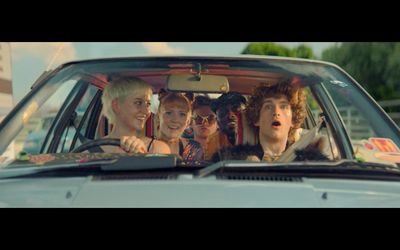 a group of young people sitting in a car