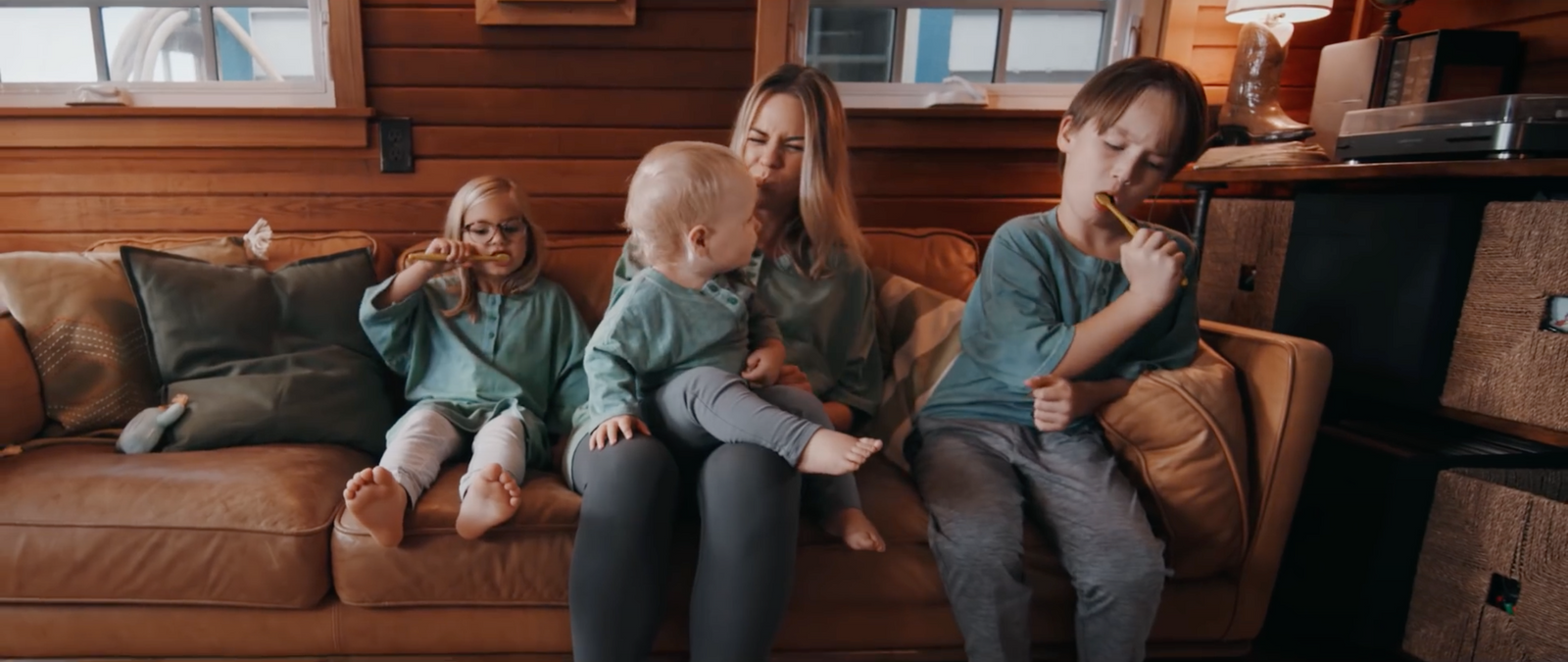 a group of children sitting on top of a couch