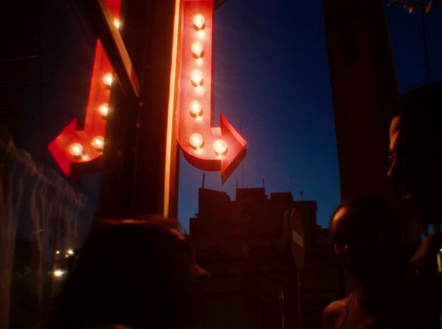 a large neon sign with lights hanging from it's sides