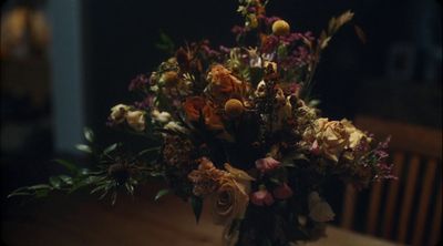 a bouquet of flowers sitting on top of a wooden table