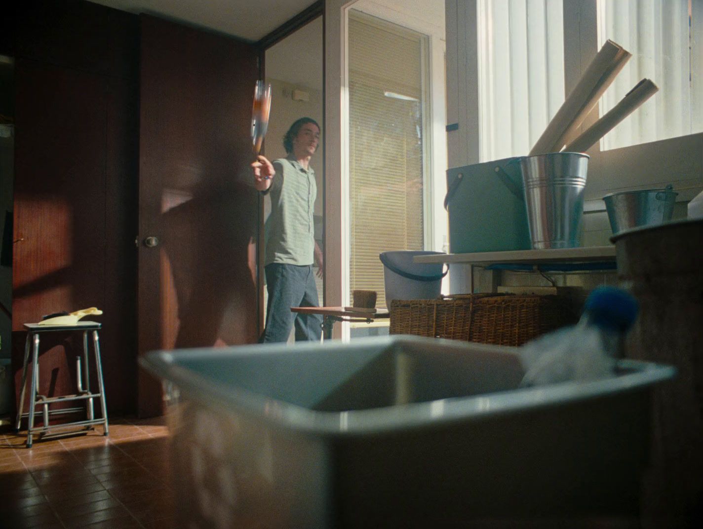 a man standing in a room holding a baseball bat