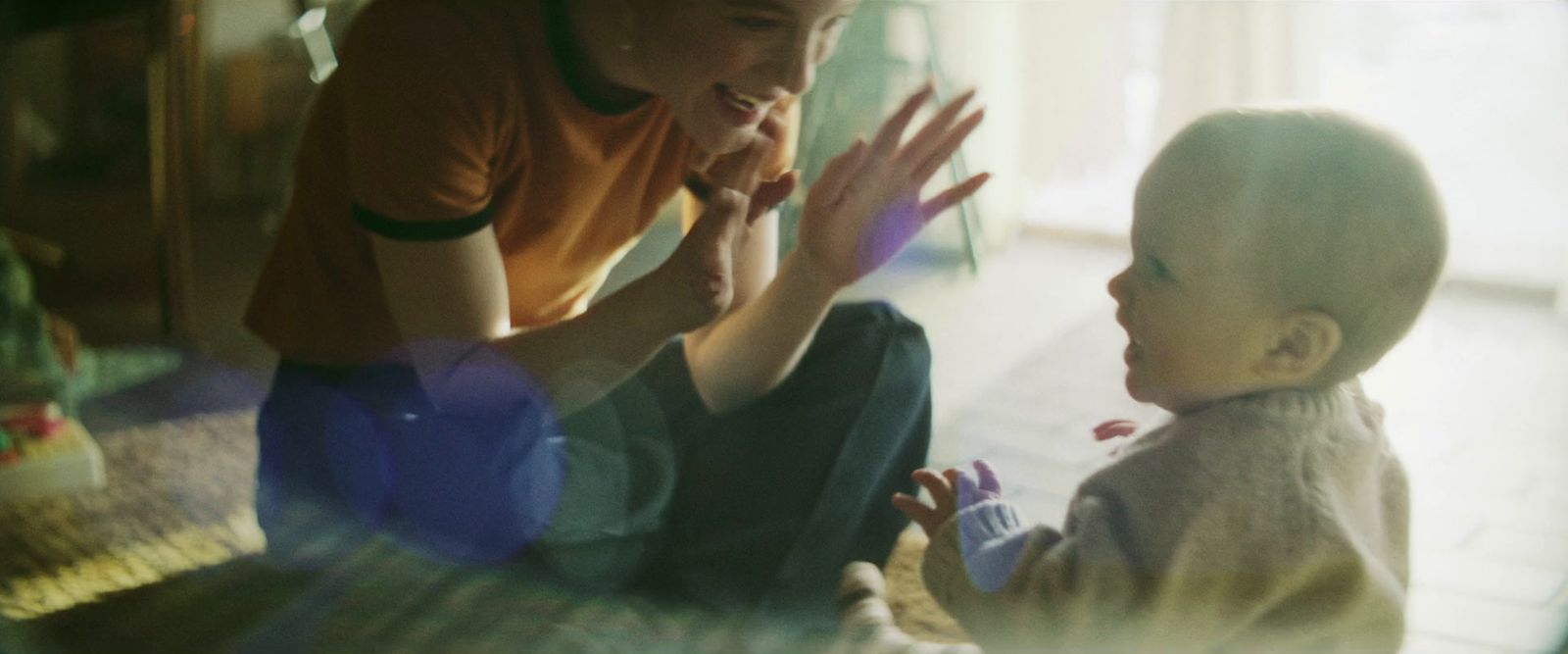 a man kneeling down next to a small child