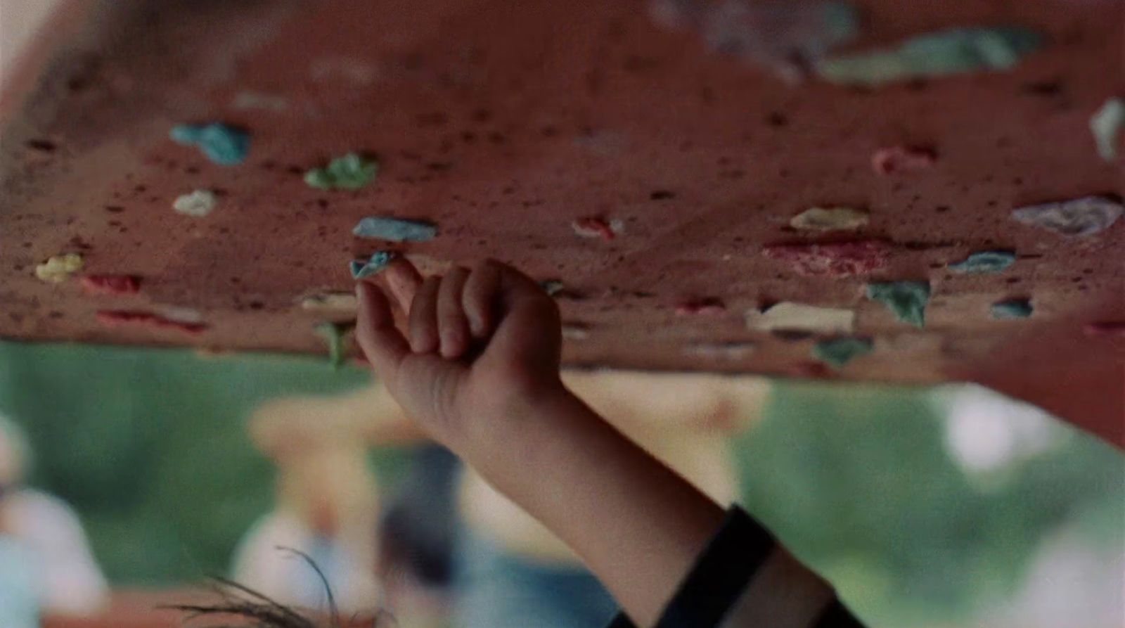 a close up of a person holding a board above their head