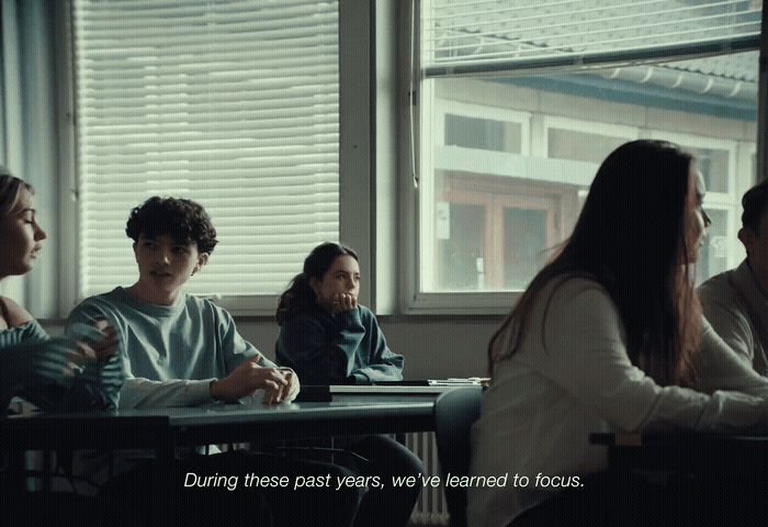 a group of people sitting at a table in front of a window