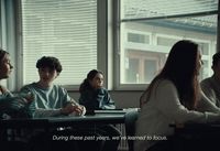 a group of people sitting at a table in front of a window
