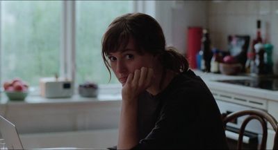a woman sitting in front of a laptop computer