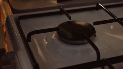 a close up of a stove top with a spoon on it