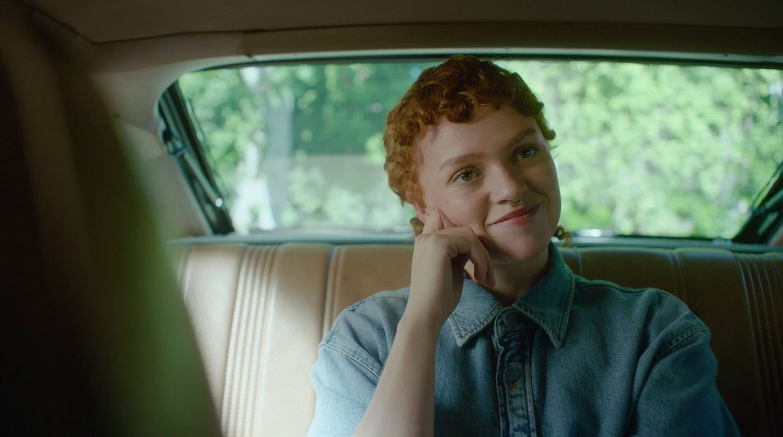 a woman sitting in the back seat of a car