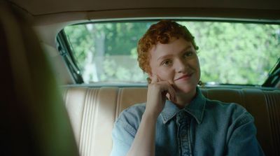 a woman sitting in the back seat of a car
