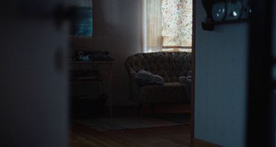 a living room with a chair and a window
