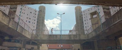 a couple of people walking across a bridge