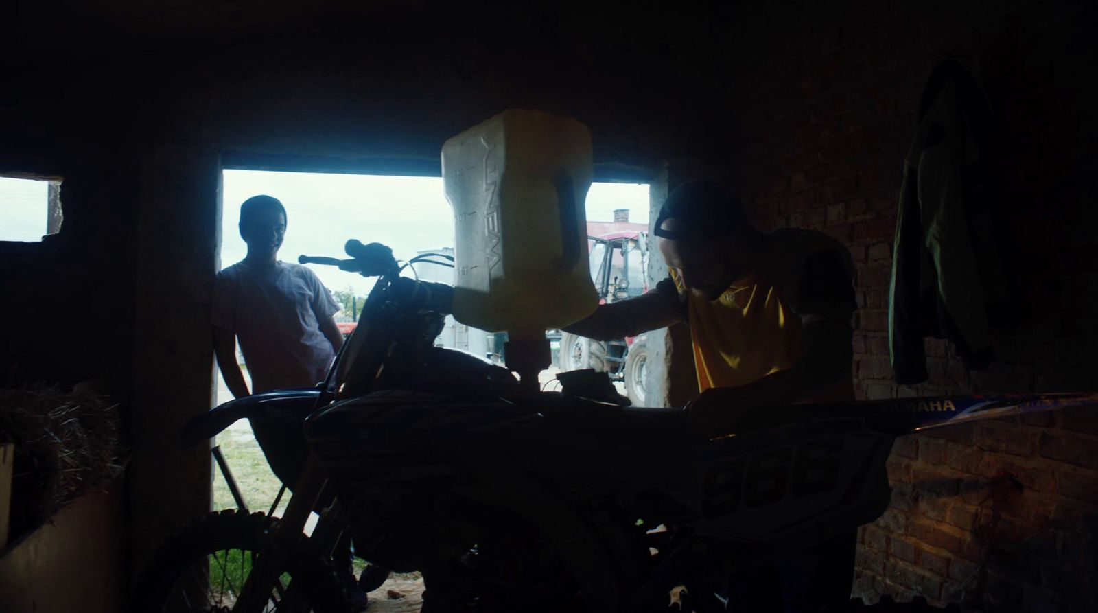 a man standing next to a motorcycle in a garage