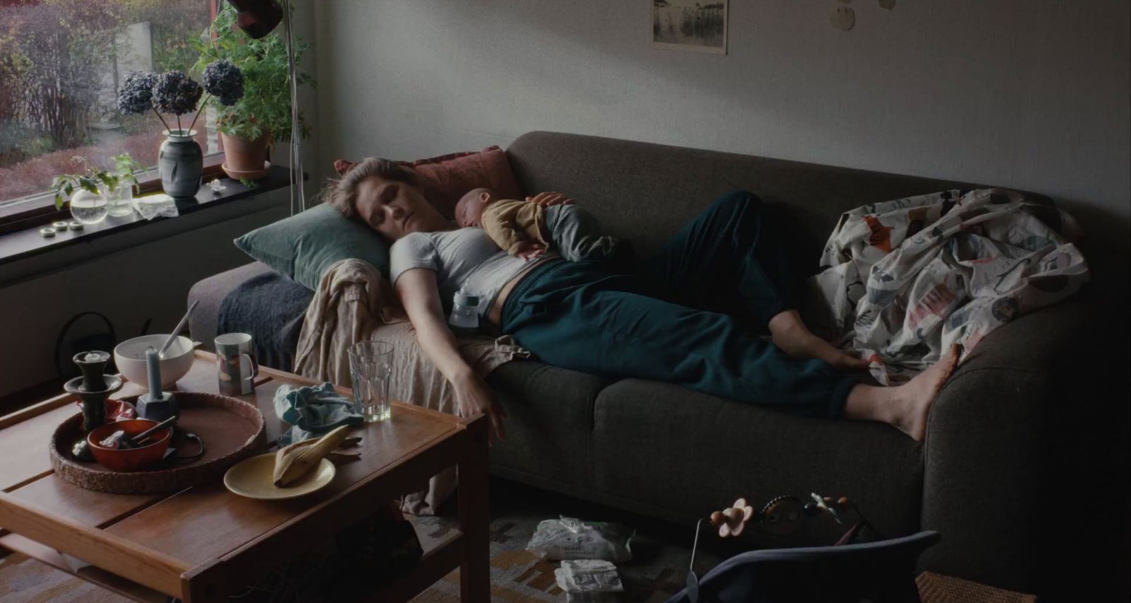a person laying on a couch with a cat